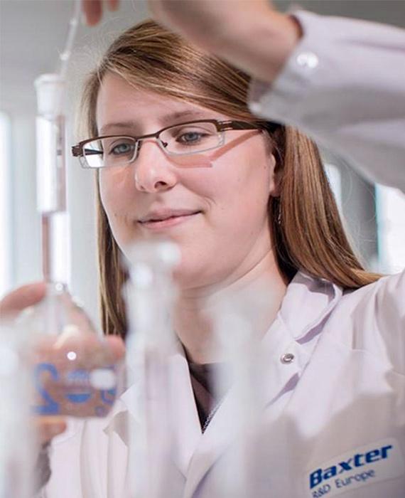Baxter employees with Beaker in Lab - Homepage - Right image Baxter employees with Beaker in Lab